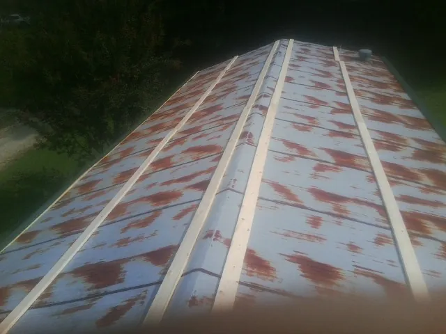 Rusted metal roof panels with new wood purlins before replacement — Storm Damage Roof Repair in Culver City by Roofing Brothers